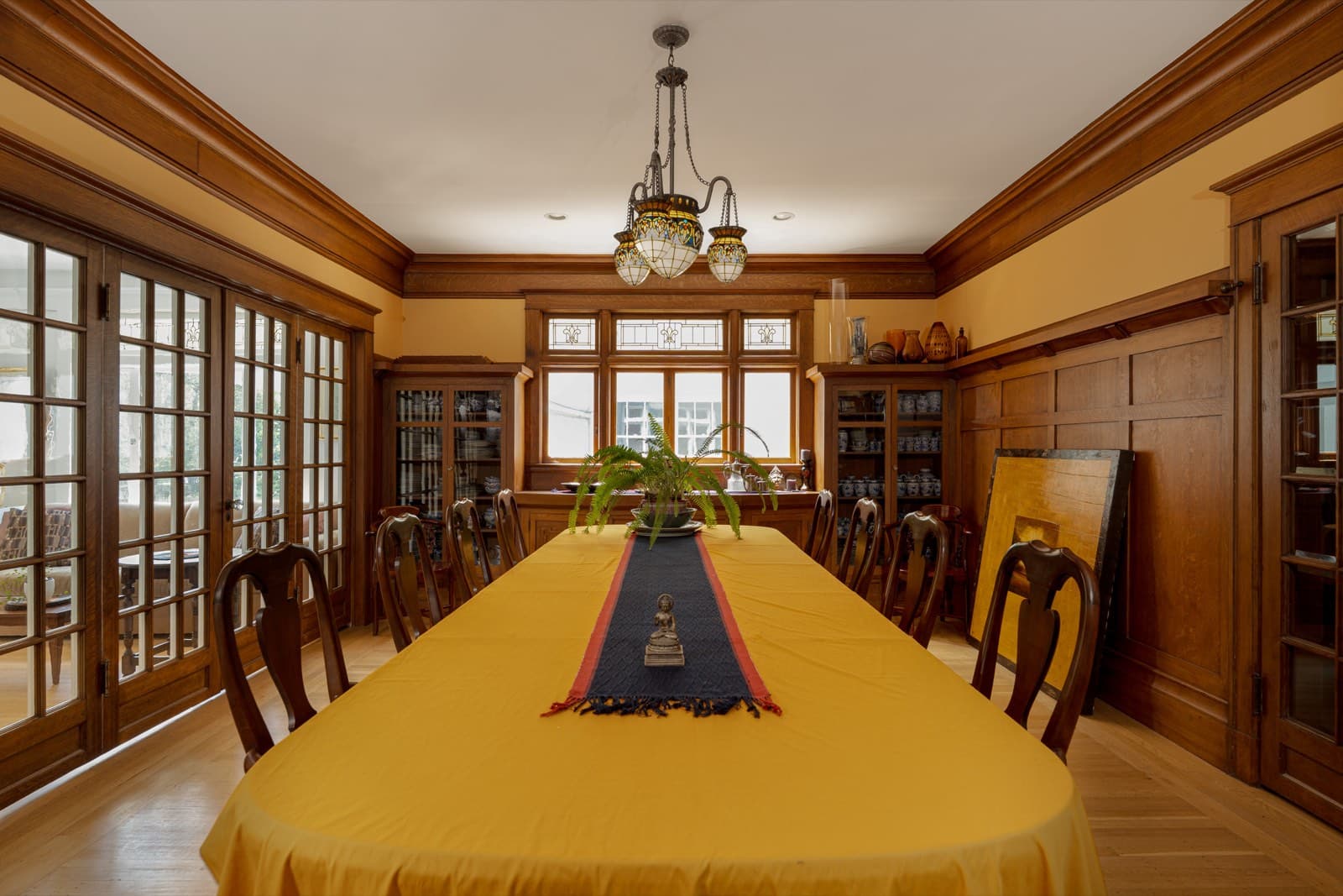 The same dining room with the paneling and cabinets stripped back to wood