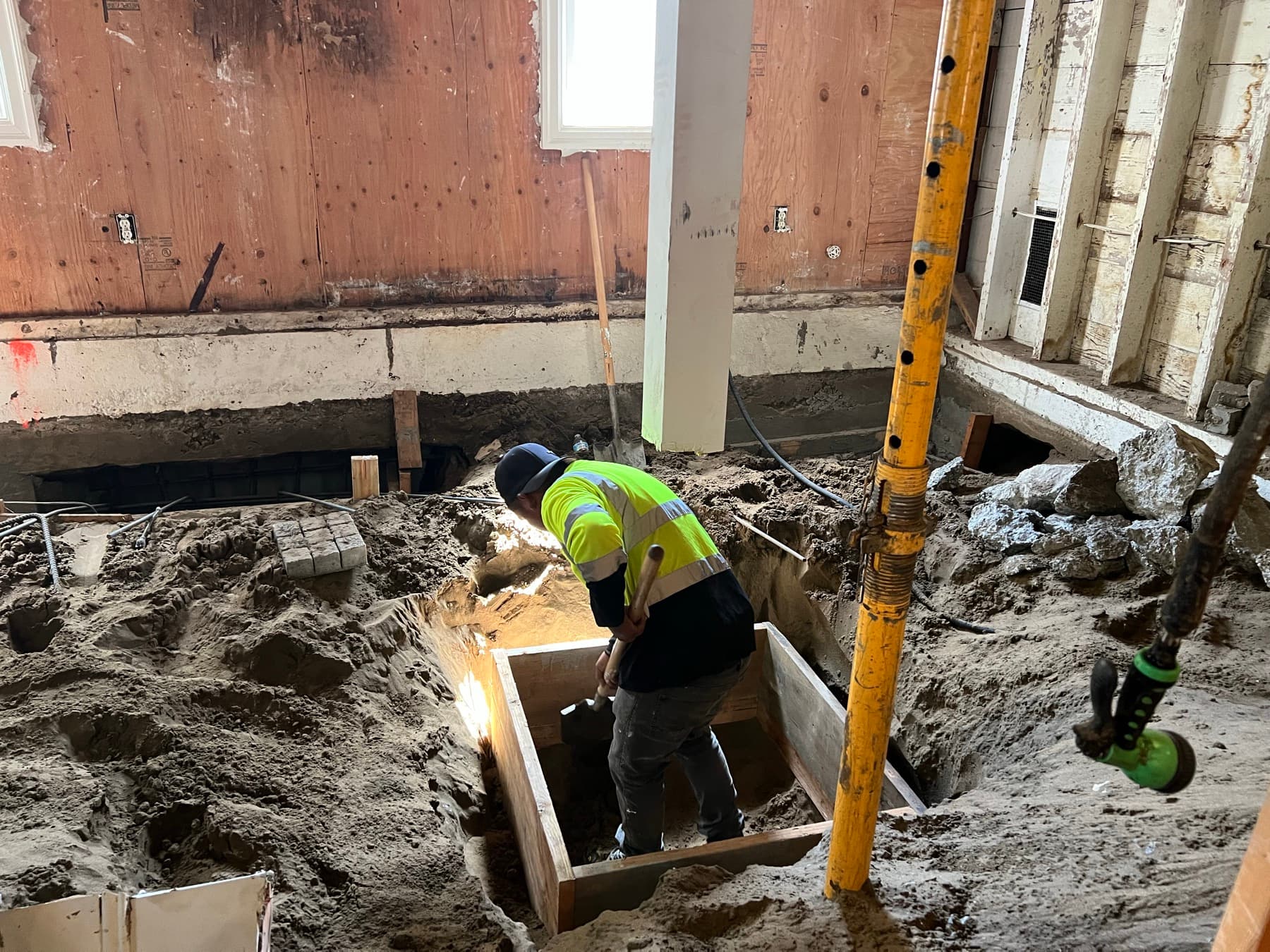 Underpinning the foundation: digging beneath the original footing to form a new one below it