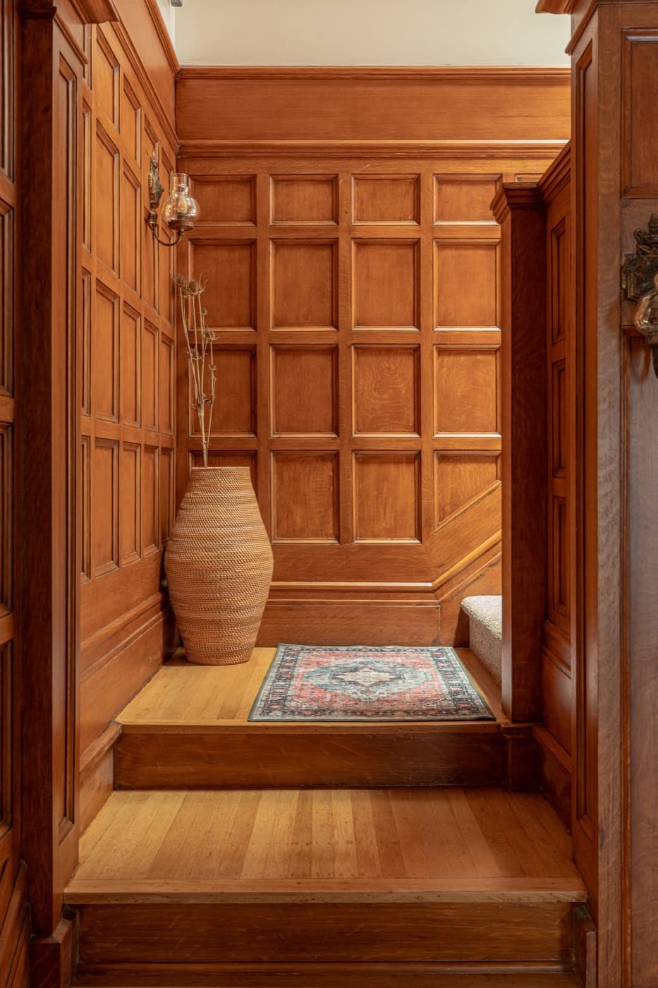 Paneled alcove at the foot of the staircase