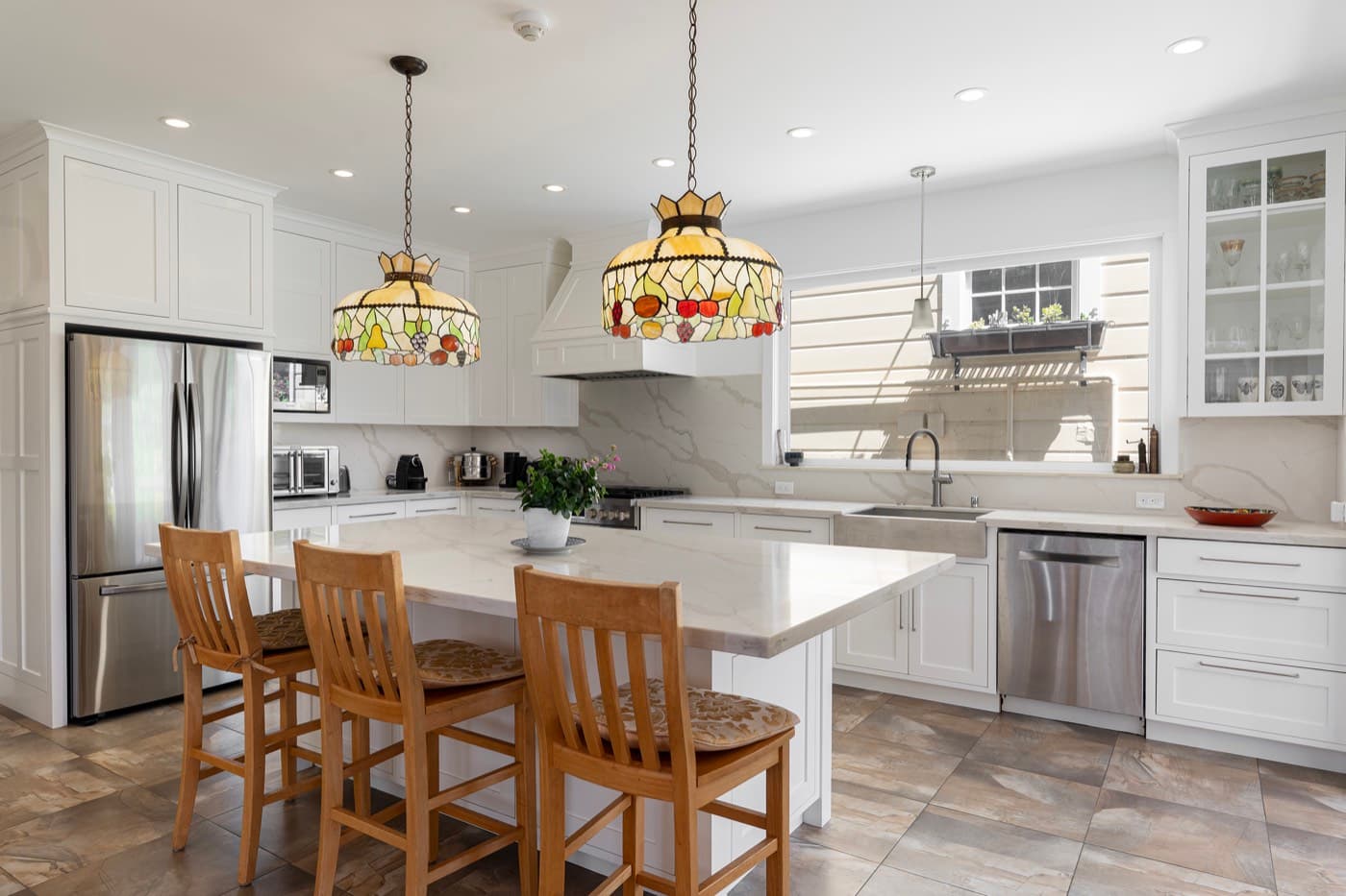 The finished kitchen from the doorway: island seating for six, and the room opened end to end