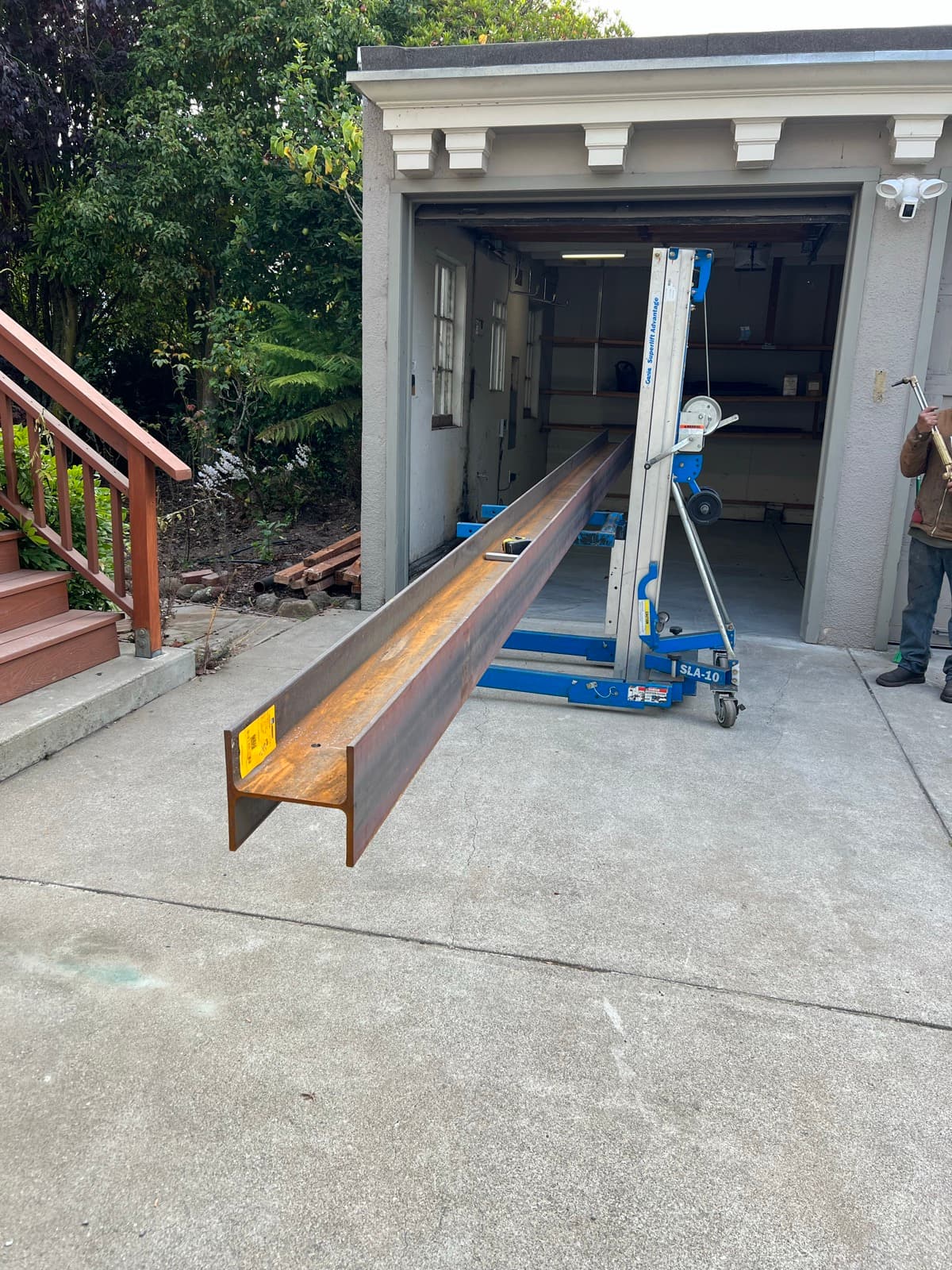 The steel beam on the driveway beside the material lift, before it was raised into the house