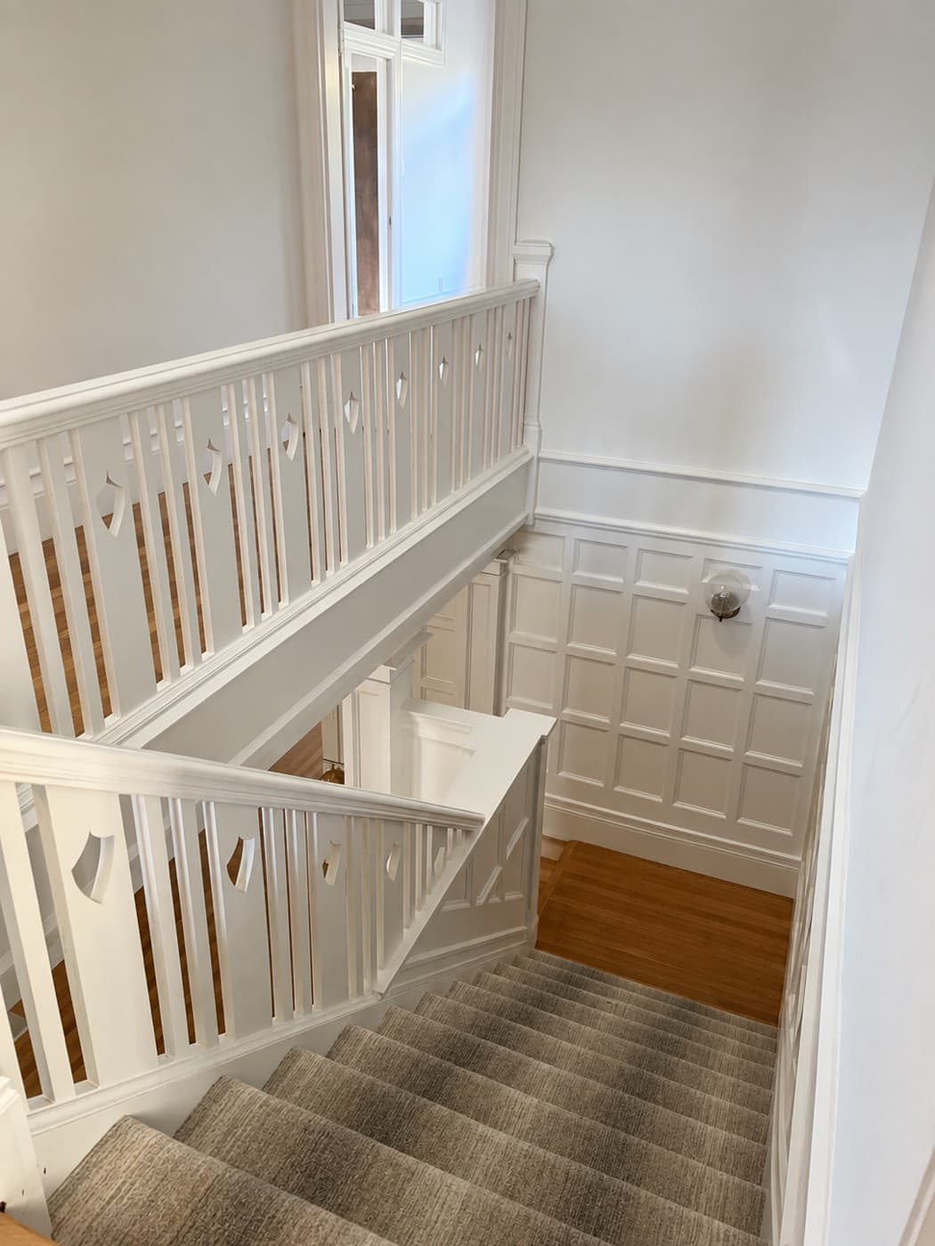 Staircase with balustrade and paneling painted white